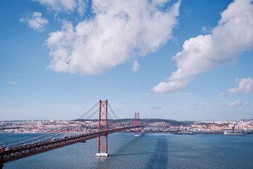 Beautiful landscape with suspension 25 April bridge bridge over the Tagus river in Lisbon, Portugal.
