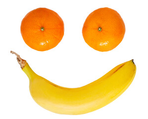 Smiling emoticon on a white background made of fruits - eyes made of tangerines, mouth made of banana