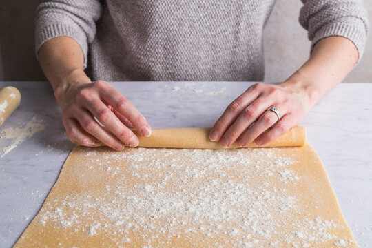 Rolling up pasta dough into a tube shape