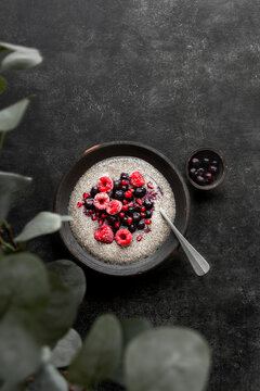 Chia seed pudding, topped with raspberries, blueberries and pomegrante seeds