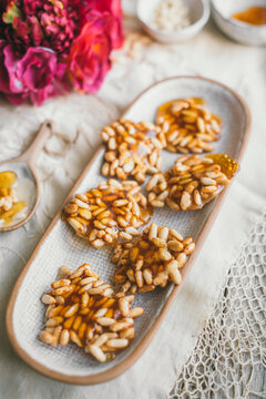 Pine Nut Caramel biscuits on a white ceramic plate
