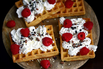 Soft focus. Macro. French waffles with cream and fresh raspberries.