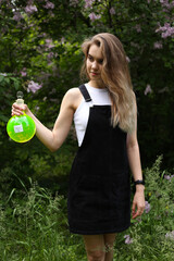 An attractive blonde witch stands in full length with a flask in her hands. In the flask is a love...