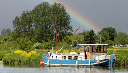 boat on the river with rainbow