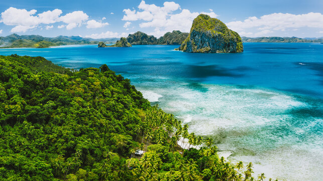 El Nido, Palawan, Philippines. Panoramic aerial view of exotic tropical Pinagbuyutan island, blue sea, lagoon and palm trees. Southeast Asia Bacuit archipelago