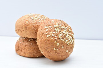Round wholemeal oat bread, sweetened with natural panela, displayed on white wood