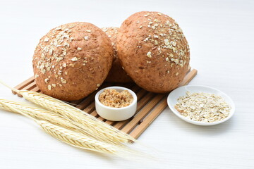 Round wholemeal oat bread, sweetened with natural panela, displayed on white wood