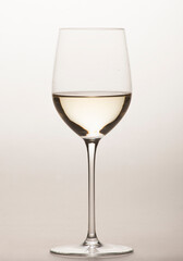 white wine in a special glass for white wine close-up in the studio on a light background without people
