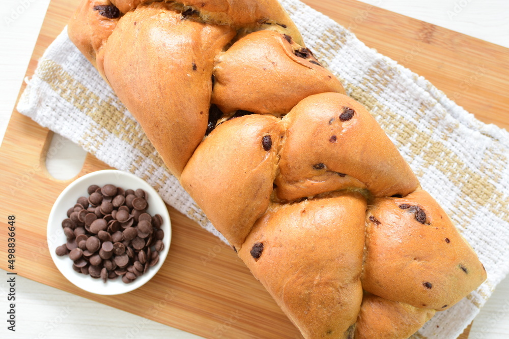 Sticker Artisanal bread with a touch of chocolate, displayed on white wood