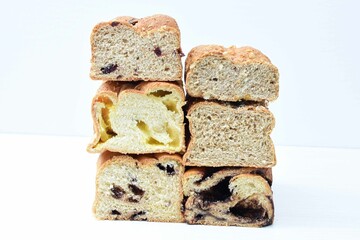 Mix of artisan breads of different natural flavors, displayed on a wooden background