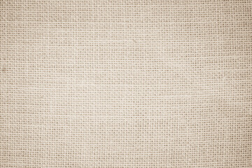 Jute hessian sackcloth burlap canvas woven texture background pattern in light beige cream brown color blank decoration.

