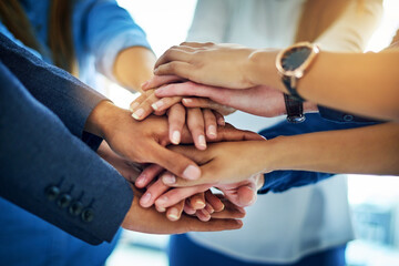 As a team well go far. Cropped shot of a group of unrecognizable businesspeople joining their hands together in unity.