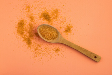 Organic brown sugar in two ceramic spoons - Saccharum officinarum