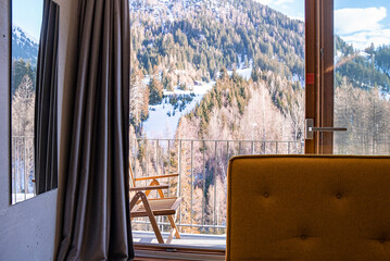 Scenic view of mountain with trees from hotel bedroom on sunny day