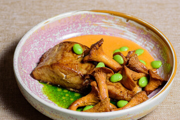 A piece of fish baked in the oven with chanterelle mushrooms and sauce