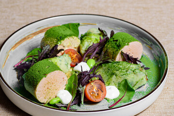 Salad with sausage, tomatoes, basil and lettuce