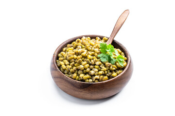 Boiled green mung beans in wooden bowl isolated on white