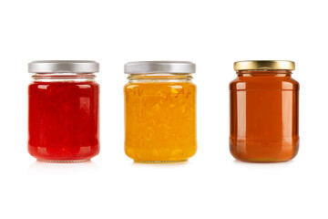 Strawberry with orange jam jar and honey isolated on white background.
