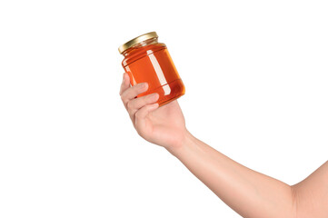 Hand holding a honey bottle on white background.