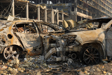 Aftermath shell of civilian bombed city damage car. 2022 Russian invasion of Ukraine war torn city...