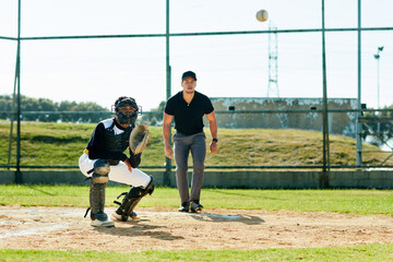 Come on, I got you. Full length shot of a young baseball player waiting to catch a ball during a match on the field.