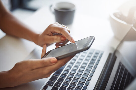 I Can Connect My Multiple Devices To Have The Same Information. Closeup Shot Of An Unrecognizable Female Designer Using A Cellphone In Her Home Office.