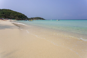 Fototapeta na wymiar beach with white sand beach wave on the white sand beach and space on blue sky on sunny day