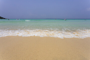 Fototapeta na wymiar wave on the white sand beach and space on blue sky on sunny day