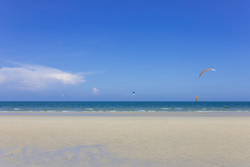 kite surfing on the beach wave on the white sand beach and space on blue sky on sunny day