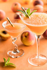 Two icy peach Bellini cocktails ready for drinking. 