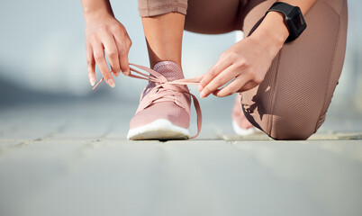 Im ready to go now. Closeup shot of an unrecognisable woman tying her laces while exercising...