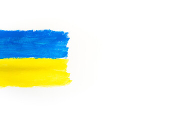 Flag of Ukraine is yellow-blue on a white background painted with paints. Flag day. Support for Ukraine. There is no war. Peace in Ukraine. Copyspace.
