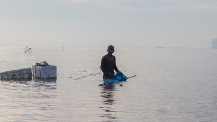 Shrimp fisherman carrying catch with Styrofoam