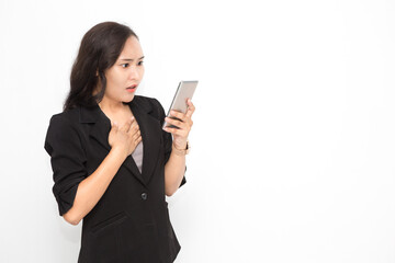 Beautiful Asian business woman wearing black suit holding smartphone on white background and copy space.  Cute Asian working woman shocked something on her smartphone for social media concept