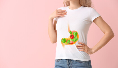 Young woman after eating healthy food on pink background. Weight loss concept