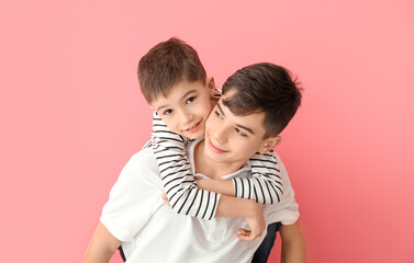 Portrait of cute brothers on color background