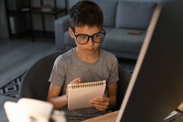 Cute little programmer using modern computer at home
