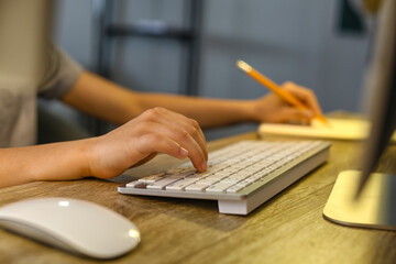 Cute little programmer using modern computer at home