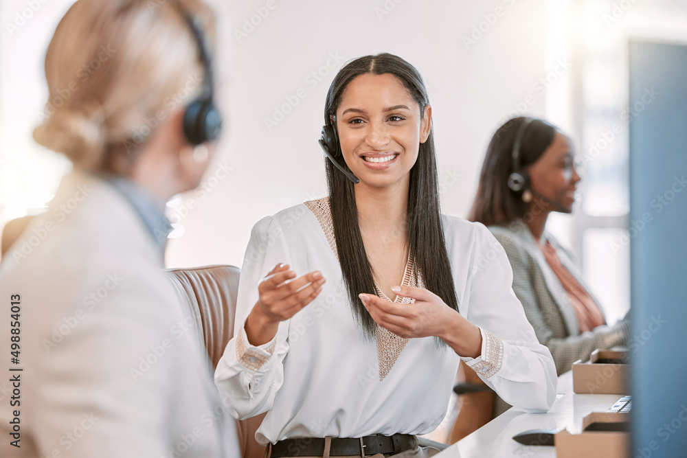 Poster showing her the ropes. cropped shot of an attractive young call center agent wearing a headset and c