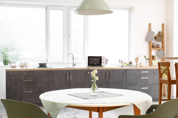 Dining table with chairs in modern interior of kitchen