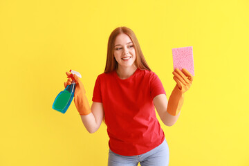 Young woman with sponge and detergent on color background