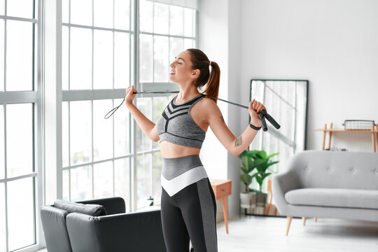 Sporty Young Woman With Skipping Rope At Home