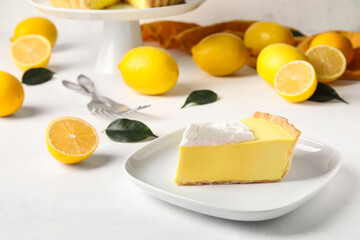 Plate with piece of tasty baked lemon pie on white background