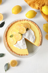 Stand with tasty baked lemon pie and fresh fruits on white background