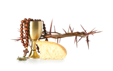 Cup of wine with bread, rosary and crown of thorns on white background