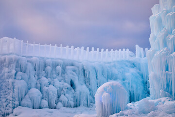 Winter ice and snow forming beautiful gigantic icicles on a freezing cold day in January