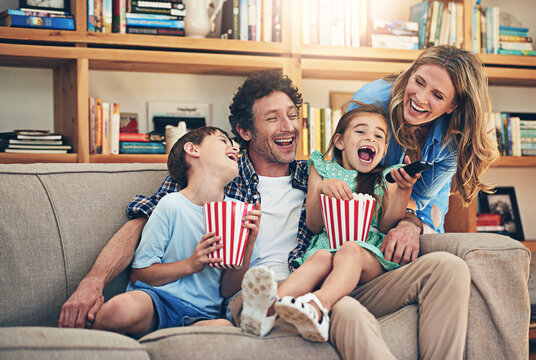 So many fun memories were made on family movie night. Shot of a happy family watching movies on the sofa at home.