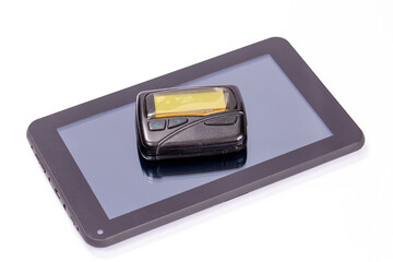 Old pager and new tablet computer on white background