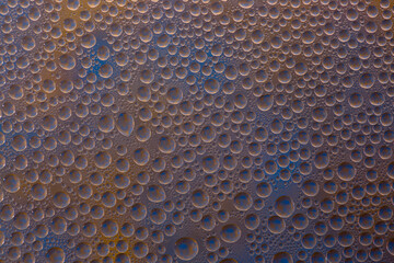 Abstract background of water droplets on the glass surface