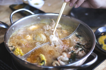 Close up Shabu hot pot on table( mix vegetable ,pork, beef,corn, seafood)